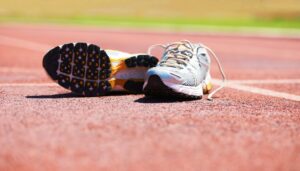 Taking a break from the race. A pair of running shoes lying on a running track.